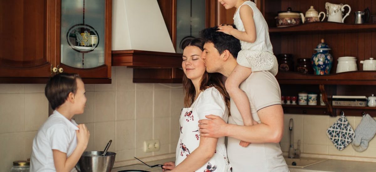A joyful family enjoying cooking and spending quality time together in the kitchen.