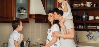 A joyful family enjoying cooking and spending quality time together in the kitchen.