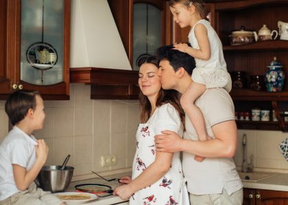 A joyful family enjoying cooking and spending quality time together in the kitchen.